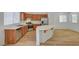 Bright kitchen with wood cabinets, stainless appliances, and island flows into the living area at 9204 Weeping Hollow Ave, Las Vegas, NV 89178