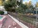 Landscaped backyard with trees and pathway at 9604 Rancho Palmas Dr, Las Vegas, NV 89117