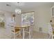 Open dining area with large window and chandelier at 9604 Rancho Palmas Dr, Las Vegas, NV 89117