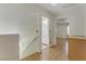 Upstairs hallway with wood-look floors and bathroom access at 9604 Rancho Palmas Dr, Las Vegas, NV 89117