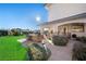 Landscaped backyard with outdoor kitchen and walkway at 9605 Verlaine Ct, Las Vegas, NV 89145