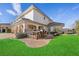 Outdoor kitchen and seating area with grassy lawn at 9605 Verlaine Ct, Las Vegas, NV 89145