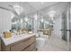 Luxury bathroom features a double vanity, a large mirror, and a chandelier at 9605 Verlaine Ct, Las Vegas, NV 89145