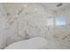 Elegant bathroom featuring marble walls and a soaking tub at 9605 Verlaine Ct, Las Vegas, NV 89145