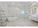 Luxury bathroom with marble walls, freestanding tub, and glass shower at 9605 Verlaine Ct, Las Vegas, NV 89145