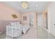 Peaceful bedroom with pink walls and a round crib at 9605 Verlaine Ct, Las Vegas, NV 89145