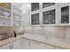 Butler's pantry with glass-front cabinets, ample storage, and granite countertop at 9605 Verlaine Ct, Las Vegas, NV 89145