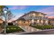 Stunning two-story home with three-car garage, detailed balconies, and a lush, landscaped yard at 9605 Verlaine Ct, Las Vegas, NV 89145