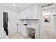 White shaker cabinets, marble countertops, and a convenient sink in the laundry room at 9605 Verlaine Ct, Las Vegas, NV 89145