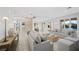 Open living room with large windows and access to kitchen at 9605 Verlaine Ct, Las Vegas, NV 89145