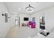 Bright playroom with built-in shelving, comfortable seating, and a large TV at 9605 Verlaine Ct, Las Vegas, NV 89145