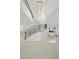 Modern curved staircase with metal railing and crystal chandelier at 9605 Verlaine Ct, Las Vegas, NV 89145