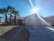 Single-story house with a two-car garage and palm trees at , North Las Vegas, NV 89031