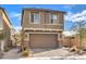 Two-story home with attached garage and front landscaping at 10066 Bismuth St, Las Vegas, NV 89183