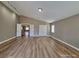 Large bedroom with wood-look floors and access to other rooms at 10279 Montes Vascos Dr, Las Vegas, NV 89178
