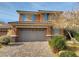 Two-story house with gray garage and blue shutters at 10279 Montes Vascos Dr, Las Vegas, NV 89178