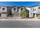 Two-story home with gray exterior, gray garage door, and landscaped front yard at 10467 Joaquin Fire St, Las Vegas, NV 89141