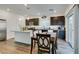 Modern kitchen with island, dark cabinets, and granite countertops at 10467 Joaquin Fire St, Las Vegas, NV 89141