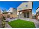 Landscaped backyard with artificial turf and covered patio at 10631 Enridge Ave, Las Vegas, NV 89166