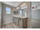 Double vanity bathroom with modern light fixtures at 10631 Enridge Ave, Las Vegas, NV 89166