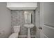 Stylish bathroom with pedestal sink and hexagon patterned wall tiles at 10631 Enridge Ave, Las Vegas, NV 89166