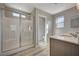 Modern bathroom with walk-in shower and double vanity at 10631 Enridge Ave, Las Vegas, NV 89166