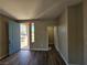 Light and airy entryway with wood-look floors and blue door at 10733 Moon Flower Arbor Pl, Las Vegas, NV 89144