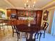 Elegant dining room features a rich wood table and cabinetry, creating a sophisticated atmosphere at 1142 Sax Fifth Ave, Henderson, NV 89052