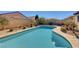 Inviting pool with a relaxing, curved design in sunny backyard at 2470 Lothian St, Henderson, NV 89044