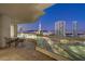 Night view from a condo balcony featuring city lights and a table with chairs at 2777 Paradise Rd # 2001, Las Vegas, NV 89109