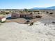 Aerial view of a unique, single-story home with desert landscaping and distant mountain views at 3281 Mark Rd, Pahrump, NV 89060