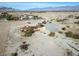 Aerial view showcasing a house with solar panels and desert landscape at 3281 Mark Rd, Pahrump, NV 89060