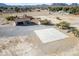 Aerial view showing house, detached garage, and large paved area at 3281 Mark Rd, Pahrump, NV 89060