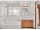 Bright bathroom featuring a tub, shower, and updated vanity at 3281 Mark Rd, Pahrump, NV 89060