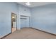 Simple bedroom with light blue walls and access to the laundry room at 3281 Mark Rd, Pahrump, NV 89060