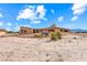 Tan colored home with unique roofline and landscaping at 3281 Mark Rd, Pahrump, NV 89060