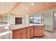 Kitchen island with wood cabinets and views to backyard at 3281 Mark Rd, Pahrump, NV 89060