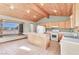 Open kitchen with island, wood cabinets and large window at 3281 Mark Rd, Pahrump, NV 89060