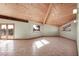 Vaulted ceiling living room with wood beams and tiled floors at 3281 Mark Rd, Pahrump, NV 89060