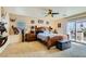 Main bedroom with a large bed, ceiling fan, and access to a patio at 394 Gatlinburg Ct, Henderson, NV 89012