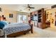Main bedroom with a large bed, built-in entertainment center and backyard access at 394 Gatlinburg Ct, Henderson, NV 89012