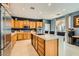 Modern kitchen with island, stainless steel appliances, and light wood cabinets at 394 Gatlinburg Ct, Henderson, NV 89012