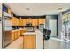 Eat-in kitchen with island seating, stainless steel appliances and wood cabinetry at 394 Gatlinburg Ct, Henderson, NV 89012