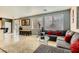 Open living room with sectional sofa, large windows, and access to kitchen at 394 Gatlinburg Ct, Henderson, NV 89012
