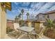 Relaxing patio features table and chairs, offering neighborhood views at 394 Gatlinburg Ct, Henderson, NV 89012