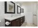 Double vanity bathroom with modern dark brown cabinets and grey tile at 4021 Flaming Peak Ct, Las Vegas, NV 89129