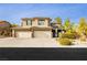 Two-story house with three-car garage and landscaped yard at 4021 Flaming Peak Ct, Las Vegas, NV 89129