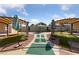 Landscaped backyard with patio, pergola, and putting green at 5098 River Glen Dr # 220, Las Vegas, NV 89103