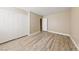 Bedroom with double door closet and wood-look floors at 5098 River Glen Dr # 220, Las Vegas, NV 89103