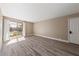 Bright living room featuring wood-look floors and access to a balcony at 5098 River Glen Dr # 220, Las Vegas, NV 89103